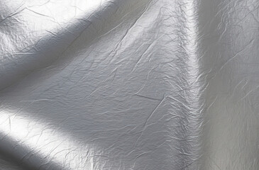 Silver foil background. Smooth surface, subtle texture, metallic.