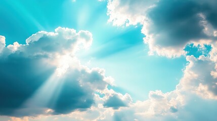 Sunbeams piercing through fluffy clouds on a vibrant sky.