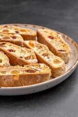 Italian Almond Biscotti biscuits in a rustic home made pottery bowl. Studded with almonds and...