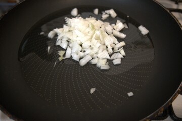 Chopped onion on oil and in frying pan.