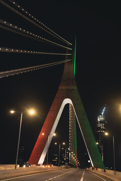Central perspective of the Alassane Ouattara Bridge illuminated at night in Abidjan