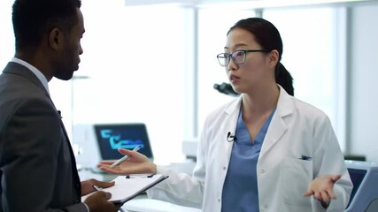 Businesspeople conferring in modern office setting - Powered by Adobe