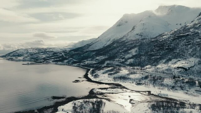 Snowy Mountains And Calm Fjord In Winter From Lodingen In Nordland, Norway. - aerial shot