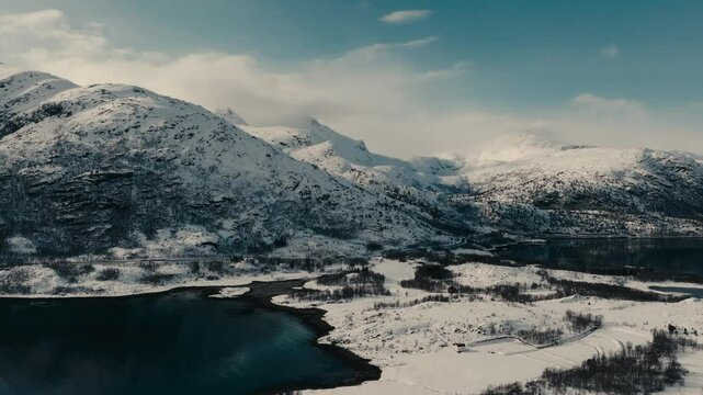 Winter Snow Mountain Ridge Over The Fishing Village Of Lodingen In Nordland County, Norway. Aerial Shot