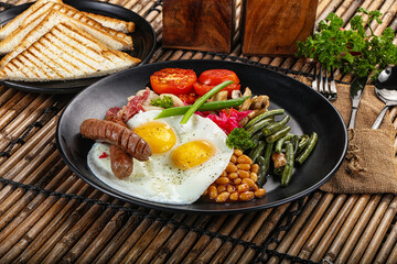 Traditional Engrlish breakfast with egg  and sausages