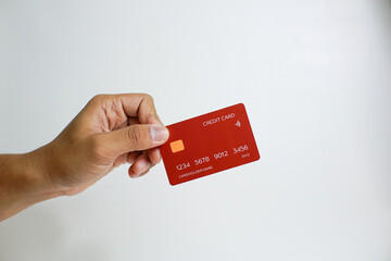 Close up of hand with red credit card isolated on white background. Shopping, finance and people concept