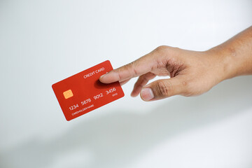 Close up of hand with red credit card isolated on white background. Shopping, finance and people concept