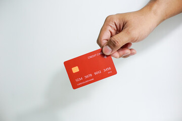 Close up of hand with red credit card isolated on white background. Shopping, finance and people concept