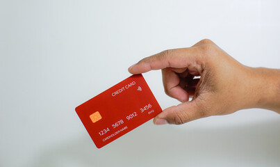 Close up of hand with red credit card isolated on white background. Shopping, finance and people concept