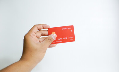 Close up of hand with red credit card isolated on white background. Shopping, finance and people concept