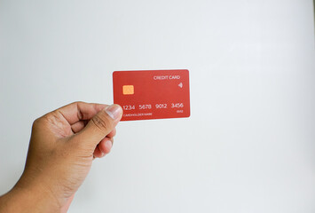 Close up of hand with red credit card isolated on white background. Shopping, finance and people concept