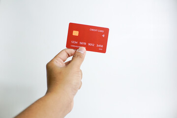 Close up of hand with red credit card isolated on white background. Shopping, finance and people concept