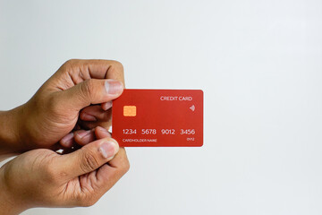 Close up of hand with red credit card isolated on white background. Shopping, finance and people concept