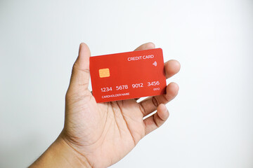 Close up of hand with red credit card isolated on white background. Shopping, finance and people concept