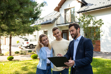 Real state agent talking to the clients after a successful deal