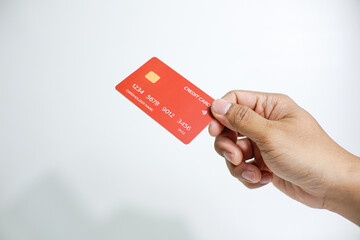Close up of hand with red credit card isolated on white background. Shopping, finance and people concept