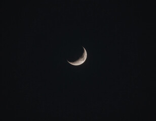 Crescent moon on black night