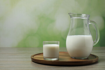jug of milk, cornflakes on wooden background
