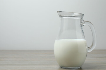 jug of milk, cornflakes on wooden background