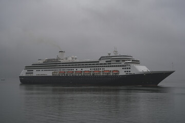 Classic cruiseship cruise ship liner Zaandam arrival into Vancouver, Canada port on grey foggy misty morning from Alaska cruise British Columbia rain day