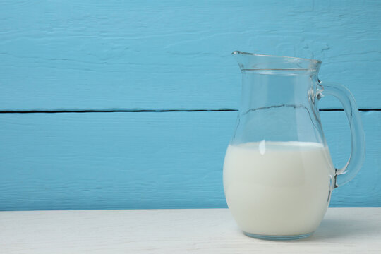 jug of milk, cornflakes on wooden background