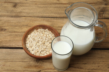 glass of oat milk and oatmeal on a wooden table.