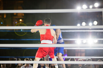 Fight of sportsmen in gloves in the ring