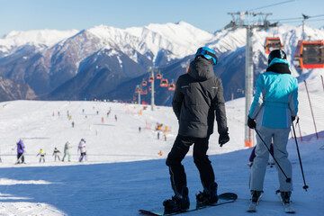 Skiers, snowboarders skiing in a mountain ski