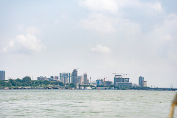 Naklejka premium Modern skyline of Abidjan – View of the Plateau construction sites from the Ébrié lagoon