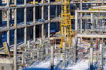 Tall building under construction with scaffolds,Freestanding tower crane on a building...