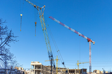 Tall building under construction with scaffolds,Freestanding tower crane on a building...