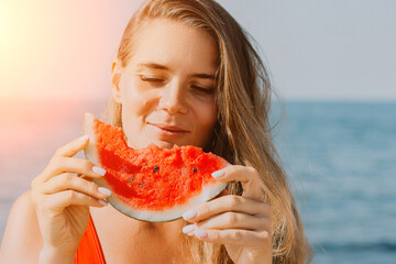 Watermelon Beach Summer: Woman enjoys refreshing watermelon slice by ocean during sunny day.