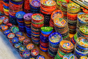 Many colorful souvenir plates for sale at the bazaar in Turkey