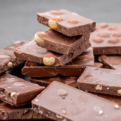 Chocolate cupcake with icing and chocolate bar in Dark lighting,Homemade delicious chocolate muffin on wooden background close-up