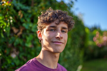 Teenage girl grinning, standing amid colorful blooming flowers, radiating joy under warm sunlight, embodying youthful energy