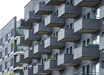 Rows of geometric balconies on a contemporary apartment building in amsterdam, showcasing urban architectural design and city living