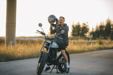 Motorcyclist putting on helmet before riding his motorcycle