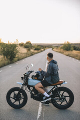 Obraz premium Biker sitting on motorcycle looking at the road ahead