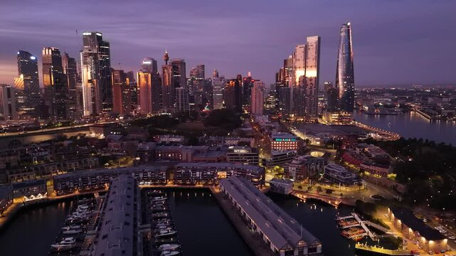 Aerial drone view from above Walsh Bay looking to Sydney City and Barangaroo waterfront precinct, NSW Australia during an early morning sunrise in July 2025     