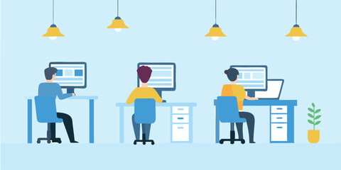 Three people working at desks with computers under hanging lights in a light blue office space