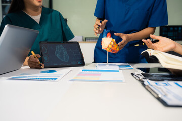 meeting and laptop for team in office in discussion, checks up with cardiologist. Doctor checkup...