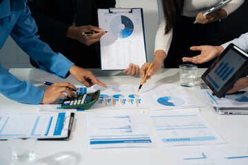 Close up Busines swoman and partner using calculator and laptop for calculation finance, tax, accounting, statistics and analytic research concept.