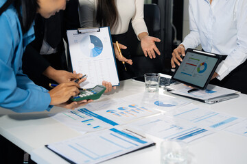Close up Busines swoman and partner using calculator and laptop for calculation finance, tax,...