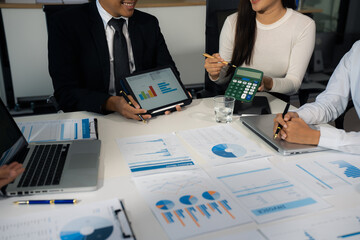 Close up Busines swoman and partner using calculator and laptop for calculation finance, tax,...
