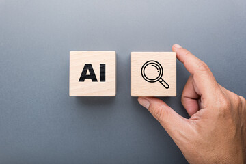 Hand holding wooden block with magnifying glass icon next to AI block represents artificial...