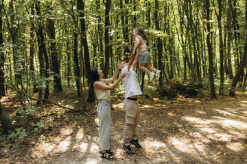 Family Enjoying a Day Together in a Sunlit Forest Setting