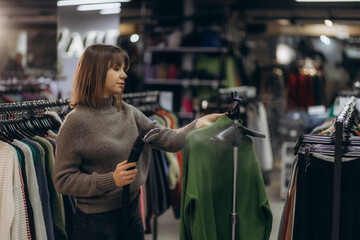 Retail Worker Steaming Clothes in a Fashion Store Setting