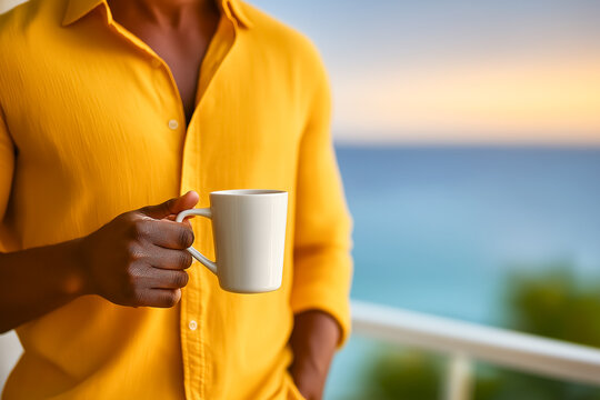 Man enjoys coffee on balcony with breathtaking ocean view at sunset. Vibrant colors fill the sky, creating a tranquil atmosphere. Concept of relaxation, vacation, wellness