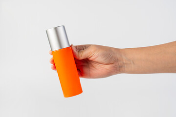 Skin care or sunscreen cosmetic and hand on white background.