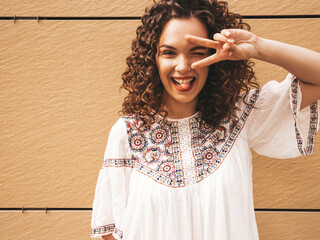 Beautiful smiling model with afro curls hairstyle dressed in summer hipster white dress.Sexy...